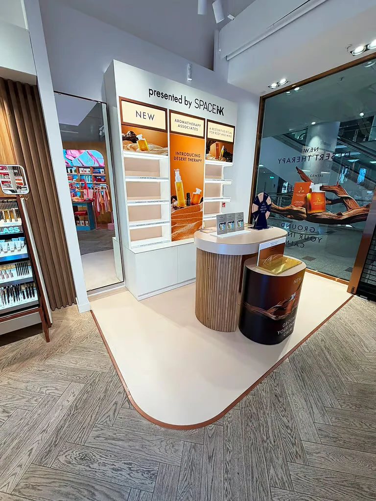 Space NK retail fixture showing the relationship between shelving and circular product podiums